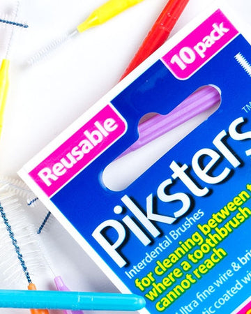 Reusable interdental brushes with a box labeled 'Pikstar' on a white background